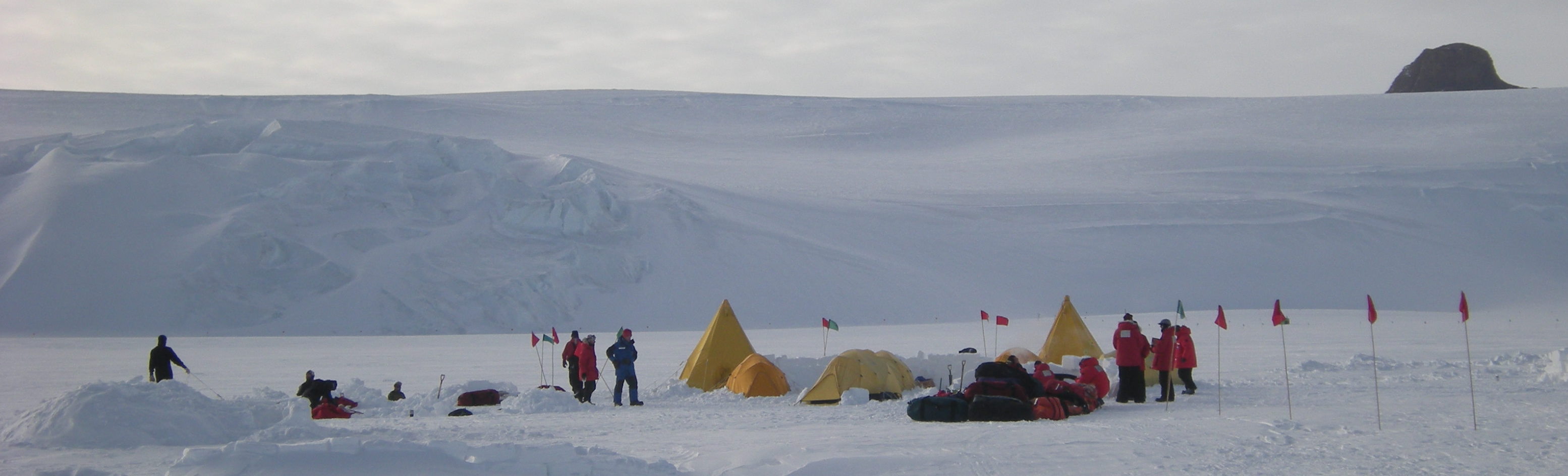 Happy Camp before we all retired for the night.  Snow huts and snow trenches are still being dug on the left, and you can see the snow wall and the two Scott tents.  The flags are so we can find our way around camp in whiteout conditions.